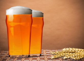 Tasty fresh beer in glass on the desk