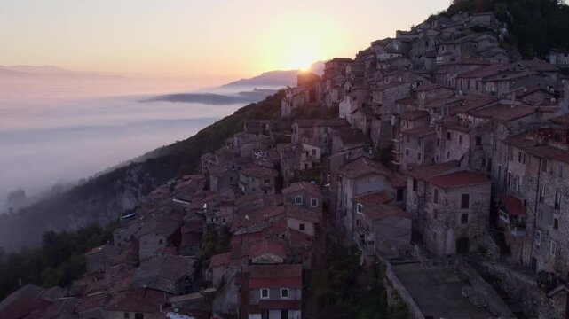 Aerial view of Santo Stefano church at sunrise with fog over the town of Artena, Rome, Italy.