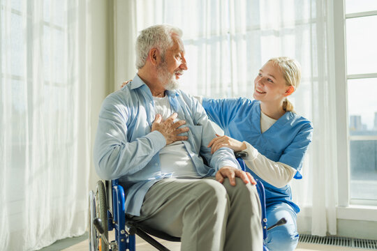 Help support retirement healthcare. Nurse helping old man in wheelchair. Patient and woman in nursing home for medical caregiver. Nurse taking care of paralyzed man in chair for people with disability
