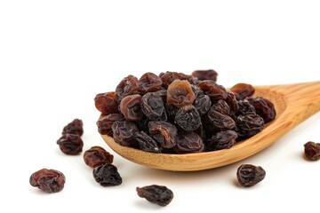 Fototapeta premium A wooden spoon filled with raisins sitting on a white surface