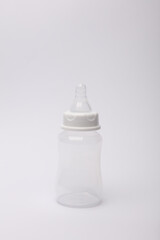 Bottle with nipple for feeding a newborn on a white background