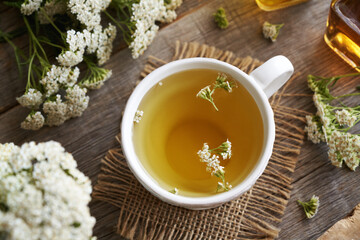 Yarrow tea in a whtie ceramic cup on a table