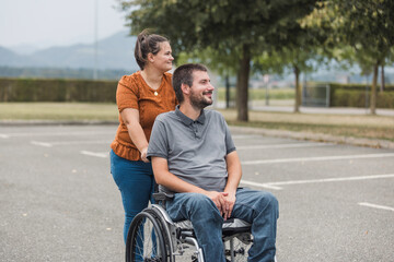 Happy and smiling man with physical disability and his female assistant having a great time...