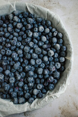 Food photography - Summer fruits blueberry background - Closeup of ripe blueberries and leaves in a baking tray