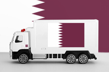 Qatar flag depicted on side wall of white delivery van close up. Shipping and local delivery concept