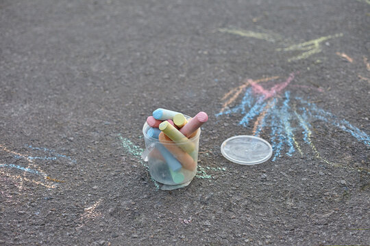 multi-colored crayons scattered on the asphalt
