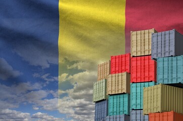Chad flag and big stack of shipping cargo containers in docks with sky background close up