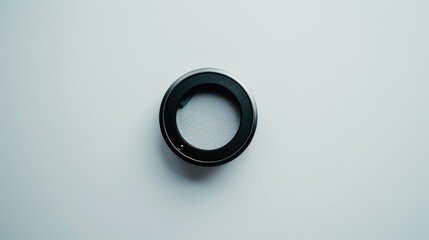 Minimalist and technical composition: camera lens filter on white background