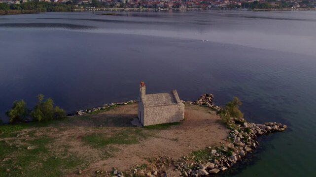 Aerial view of Duha Svetoga Church by the lake at sunrise, Posedarje, Croatia.