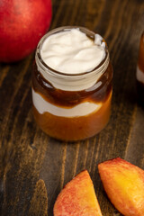 fresh yogurt with jam and pieces of ripe nectarine