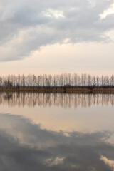 a beautiful reflection of the sky and clouds in the lake at sunset