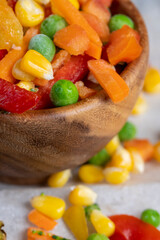a mixture of quick-frozen corn, peas, peppers, and carrots