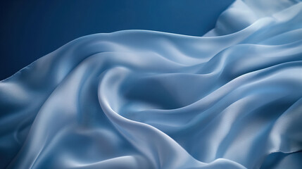 Obraz premium Light blue silk fabric draped gracefully against a dark blue backdrop