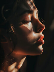 Portrait of a beautiful young woman closed her eyes, side profile photography in black background