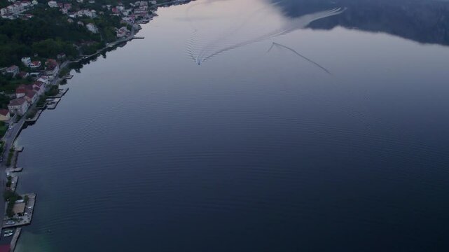 Aerial view of town, sea, mountain, fog, and sunrise, Kotor Bay, Adriatic Sea, Montenegro.