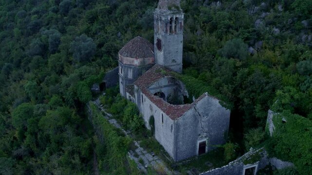 Aerial view of abandoned church and mountain in picturesque Prcanj, Kotor Bay, Montenegro.