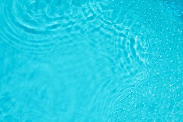 Calming Water Ripples. A soothing and close-up view of water ripples creating a serene ambiance with vibrant blue hues.