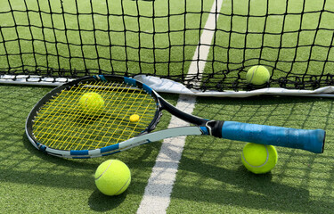 Tennis balls on a racket on the court ground