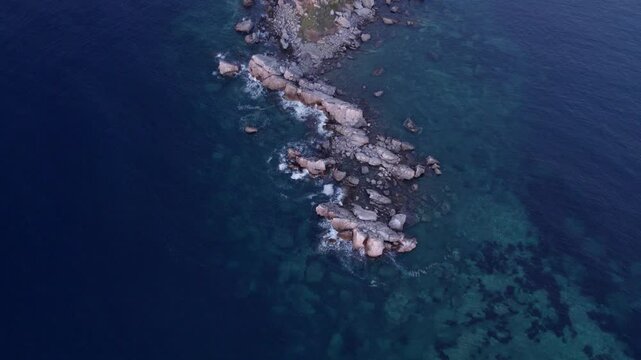 Aerial view of St. Nedjelja Church on rocky island at Mediterranean coast, Petrovac, Montenegro.