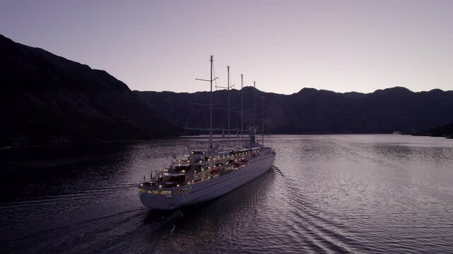 Aerial view of serene twilight over Kotor Bay with luxury cruise ship MSY Wind Surf, Montenegro.