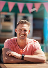 Man, portrait and smile by food truck for holiday in city, freedom by cafe for wellness. Male tourist, outdoor and relax on vacation with happiness in Canada, person in sunshine by coffee shop