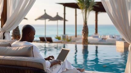 Executive working on a sleek laptop while relaxing in a private cabana at a luxury beach resort