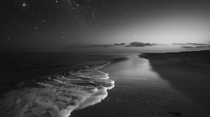 Ocean wave crashing on the beach under a starry night sky with black and white tones