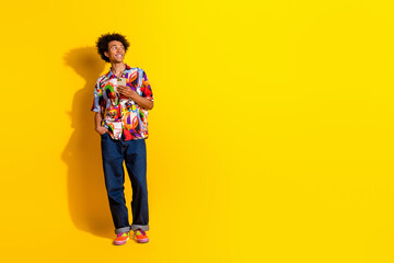 Full body portrait of nice young man hold phone look empty space wear shirt isolated on vivid yellow color background