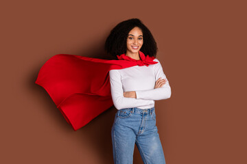 Fototapeta premium Photo of pretty young woman superhero costume folded arms isolated on brown color background