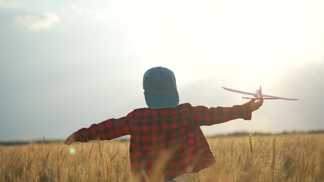 Child dream at sunset with toy plane. Sunset light captures child's travel dreams. Imaginative child play dream travel. Kid enjoys sunset dream travel adventures. Travel dream take flight at sunset.
