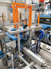 Robot palletizer orange KUKA robot kr180 stacks boxes on a pallet