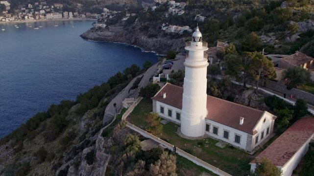 Aerial view of picturesque sunset over Balearic Sea with lighthouse, coast, and cliff, Soller, Mallorca, Spain.