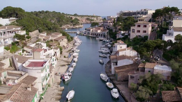 Aerial view of scenic fishing town with boats in port, Cala Figuera, Mallorca, Spain.