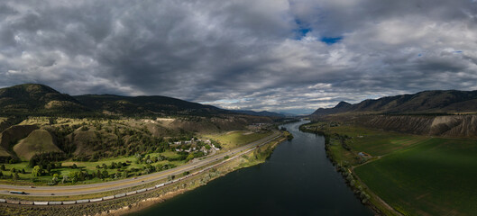 Aerial Wide Angle Panoramic Mountain Landscape and river. Canadian Nature Background.