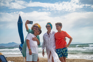 Smiling family taking a selfie on the beach