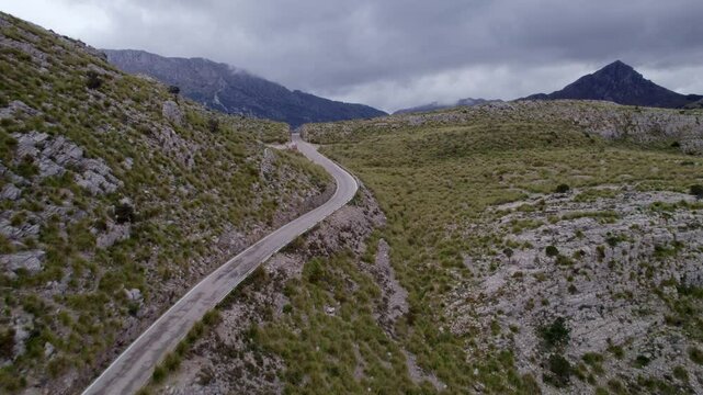 Aerial view of winding road through remote mountain pass, Coll dels Reis, Mallorca, Spain.