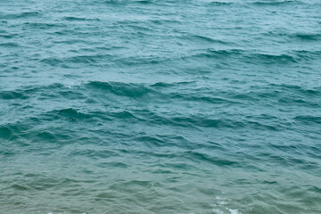 Sea water surface, wave texture. Calm seascape. The background of the blue waters of the sea. Background sea calm water.