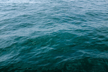 Sea water surface, wave texture. Calm seascape. The background of the blue waters of the sea. Background sea calm water.
