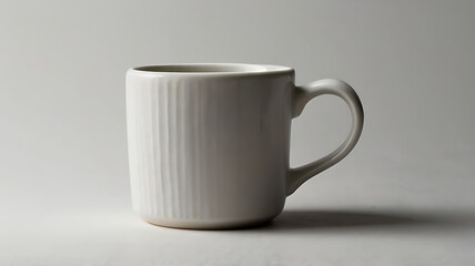Obraz premium A white ceramic coffee mug on a plain white background, with a subtle shadow to add depth