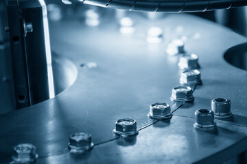 The operation of optical inspection machine in the light blue scene with nuts parts.