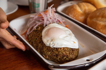 Tacu tacu with fried egg Peruvian breakfast food table with lomo saltado and pejerrey sandwich