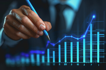 Digital businessman hand drawing growth graphs and financial data with hologram charts.