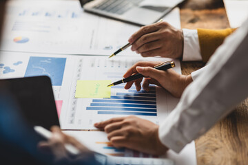 Businessman collaboration discussing working analyzing with financial data and marketing growth report graph, presentation and brainstorming to strategy planning making profit of company.