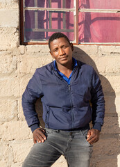 Obraz premium village single african young man in front of his house hands in the pocket