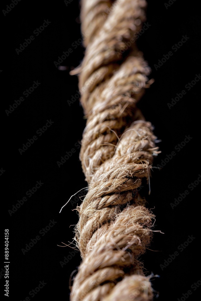 Poster a detailed view of a rope against a dark background, suitable for abstract or minimalist designs