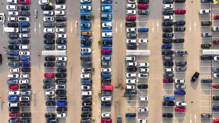 Large parking lot with many parked cars. Big carpark at shopping mall. Aerial top overhead view. 
