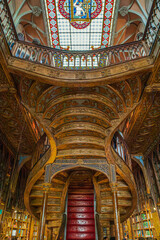 Fototapeta premium Interior of the Livraria Lello e Irmao, known as the Lello Bookshop, oldest in Portugal, dated from 1891, famous for Harry Potter film.Sumptuous interior wood staircase.Porto, Portugal