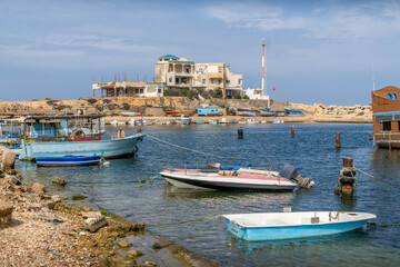 Fototapeta premium The fishing boats in Monastir, Tunisia, are in the bay of Qaraiya beach during the summer day in North Africa. 