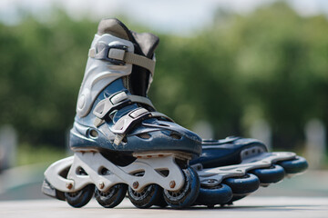 old blue roller skates lying in skate park