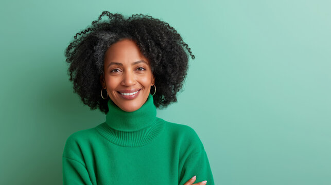 Smiling attractive woman 50s years old look to the camera, isolated on plain green background studio portrait. People lifestyle concept. 